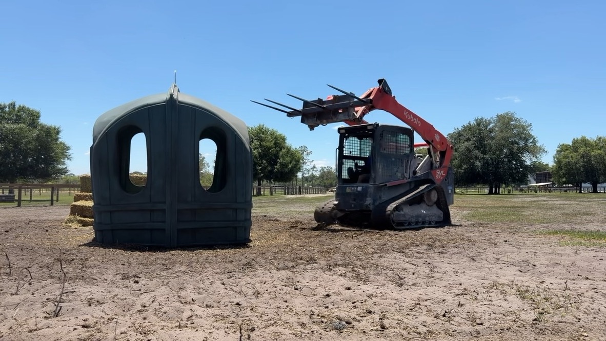 Horses feeding from a Hay Hut in a Florida pasture